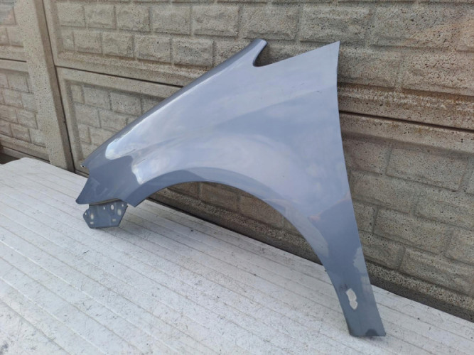 VW TOURAN LIFT BŁOTNIK LEWY 2007-2010 - (15542591029)