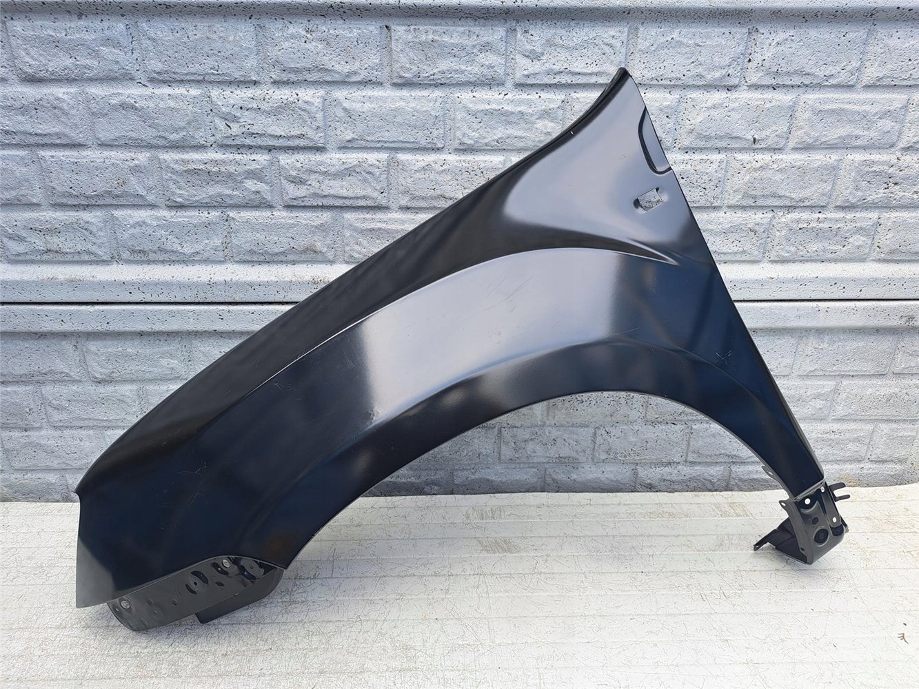 DACIA DUSTER I 1 BŁOTNIK LEWY PRZEDNI NOWY ORYGINAŁ (17387313260)