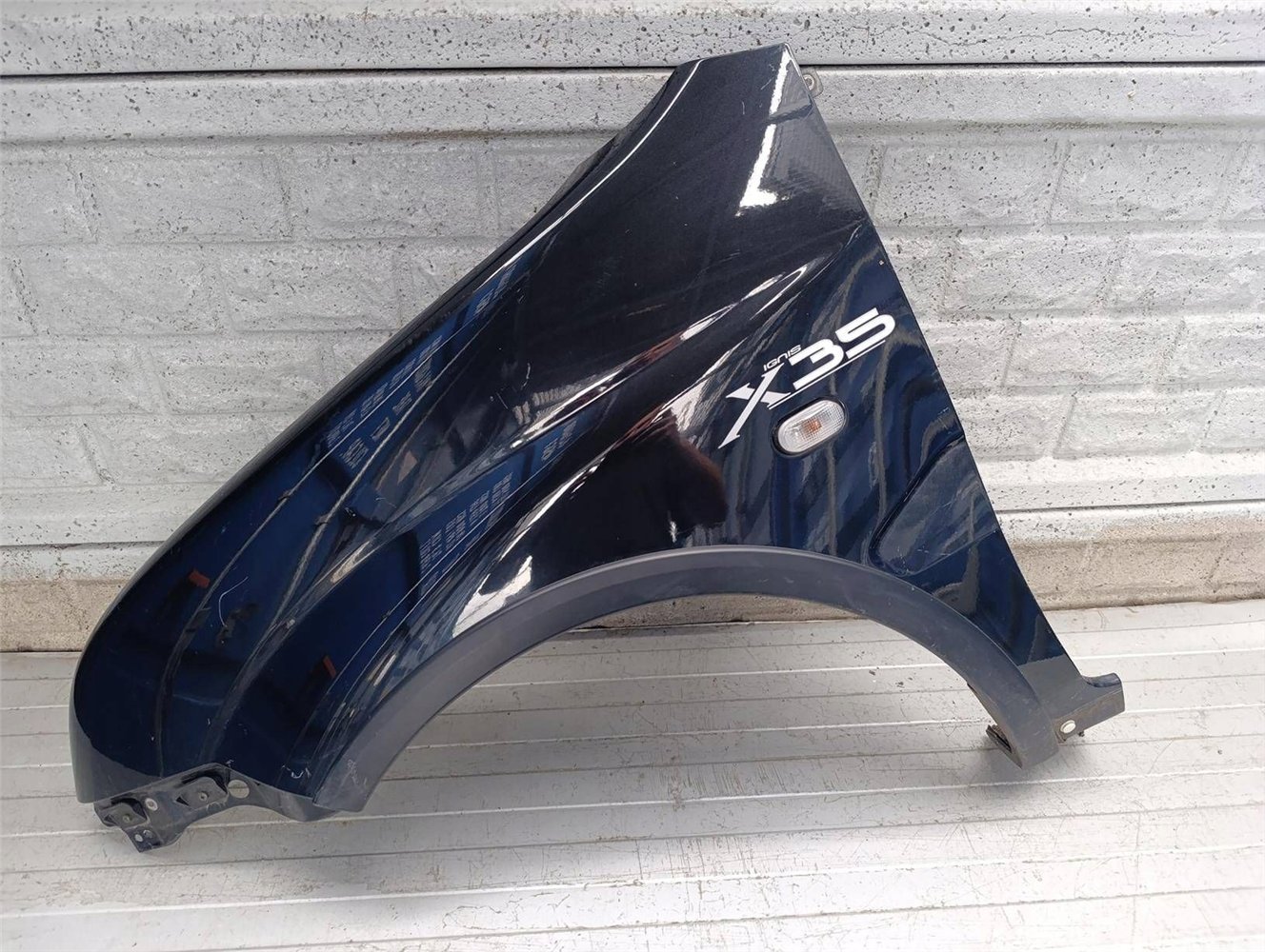 SUZUKI IGNIS II 2 2003-2010 BŁOTNIK PRZEDNI LEWY ORYGINAŁ (17854718441)