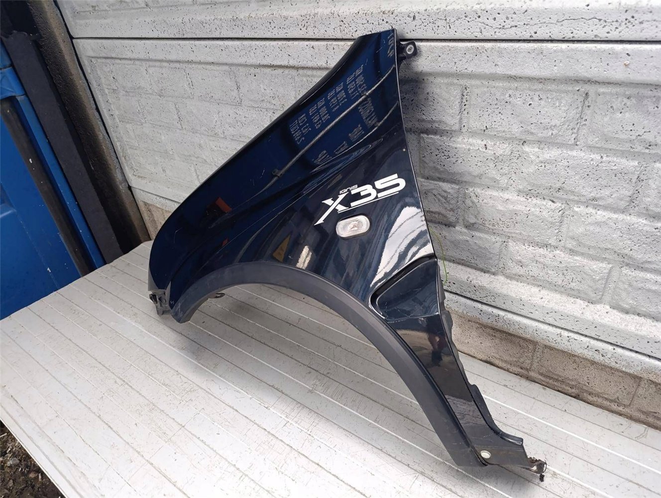 SUZUKI IGNIS II 2 2003-2010 BŁOTNIK PRZEDNI LEWY ORYGINAŁ (17854718441)