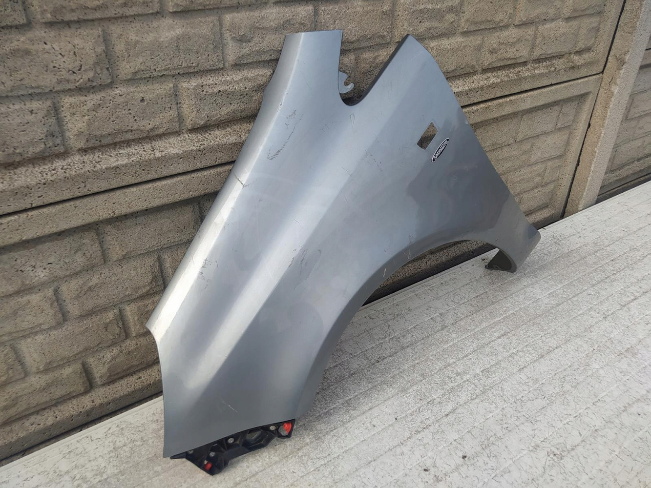 BŁOTNIK LEWY OPEL CORSA D 2006-2015 - (12516524289)